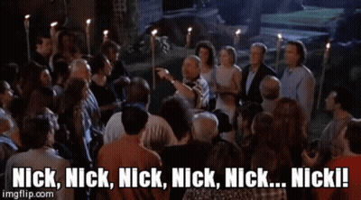 A Man And A Woman Standing Next To Each Other With The Words Nick Nick Nick Nick Nick Nick Written On The Screen GIF
