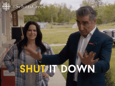 A Man And A Woman Standing Next To Each Other With The Words Shut It Down Written In Yellow GIF