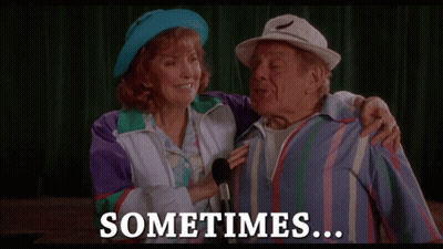 A Man And A Woman Standing Next To Each Other With The Words " Sometimes " On The Bottom GIF