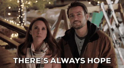 A Man And A Woman Standing Next To Each Other With The Words " There 'S Always Hope " Behind Them GIF