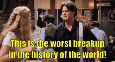 A Man And A Woman Standing Next To Each Other With The Words " This Is The Worst Breakup In The History Of The World " GIF