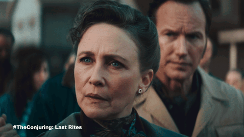 A Man And A Woman Standing Next To Each Other With #Theconjuring Last Rites Written On The Bottom GIF