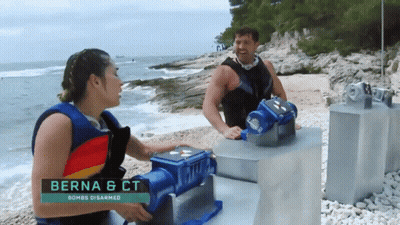 A Man And A Woman Standing On A Beach With The Name Berna & Ct On The Bottom GIF