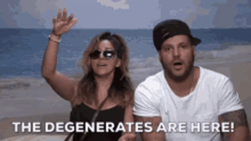 A Man And A Woman Standing On A Beach With The Words " The Degenerates Are Here " GIF