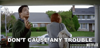 A Man And A Woman Standing On A Porch With The Words " Don 'T Cause Any Trouble " Written On The Bottom GIF