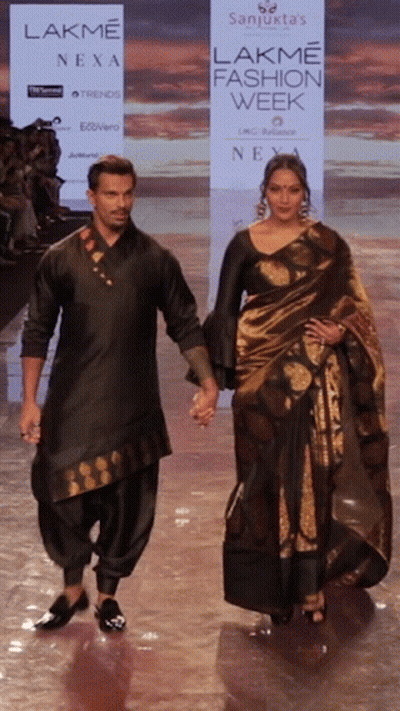 A Man And A Woman Walk Down A Ramp For Lakme Fashion Week GIF