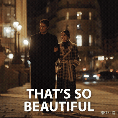 A Man And A Woman Walking Down A Street With The Words That 'S So Beautiful On The Bottom GIF