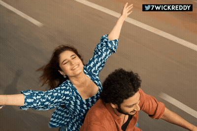 A Man And A Woman With Their Arms Outstretched And The Words 7Wickreddy Below GIF