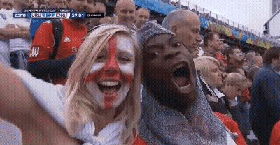 A Man And A Woman With Their Faces Painted In The Colors Of The England Flag GIF