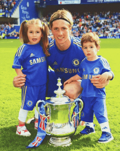 A Man And Two Children Pose For A Picture With A Trophy GIF