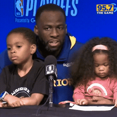 A Man And Two Children Sit In Front Of A Microphone With 95.7 The Game Written On The Bottom GIF