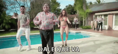 A Man And Two Women Are Dancing In Front Of A Swimming Pool With The Words Dale Que Va Above Them . GIF