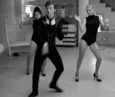 A Man And Two Women Are Dancing Together In A Black And White Photo GIF