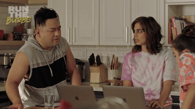 A Man And Two Women Are Looking At Laptops In A Kitchen With The Words Run The Burbs On The Bottom Right GIF