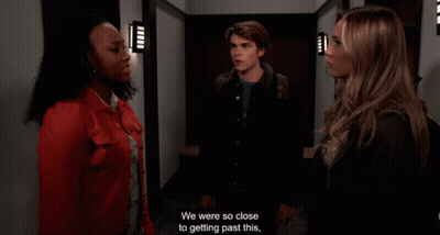 A Man And Two Women Are Standing In A Hallway And One Of Them Says " I Understand " GIF