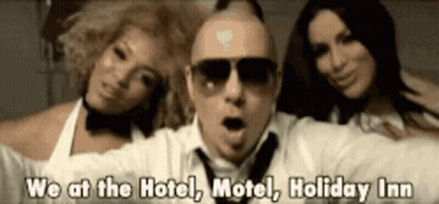 A Man And Two Women Are Standing Next To Each Other With The Words We At The Hotel Motel Holiday Inn Below Them GIF