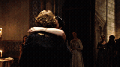 A Man And Woman Are Dancing In A Dark Room GIF