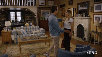 A Man And Woman Are Dancing In A Living Room With A Netflix Logo On The Bottom Right GIF