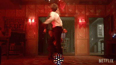 A Man And Woman Are Dancing In A Room With A Netflix Logo On The Bottom GIF