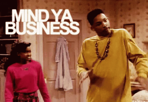 A Man And Woman Are Dancing In A Room With The Words Mind Ya Business Behind Them GIF
