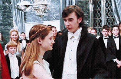 A Man And Woman Are Dancing In Front Of A Crowd Of People GIF