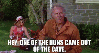 A Man And Woman Are Having A Picnic In The Grass And The Man Is Saying Hey One Of The Huns Came Out Of The Cave GIF