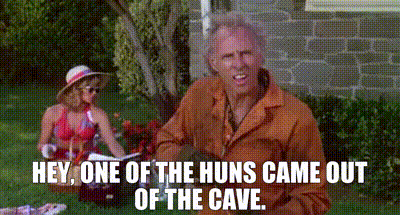 A Man And Woman Are Having A Picnic In The Grass And The Man Is Saying Hey One Of The Huns Came Out Of The Cave GIF