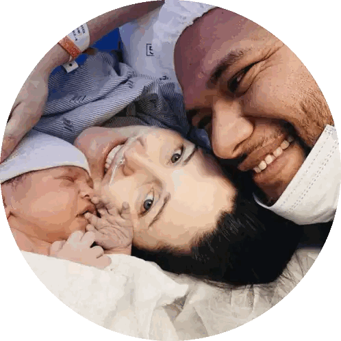 A Man And Woman Are Holding A Newborn Baby In A Hospital Sticker