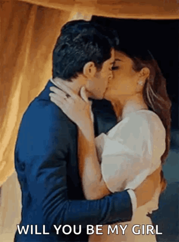 A Man And Woman Are Kissing And The Man Is Asking The Woman If She Will Be His Girl . GIF