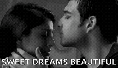 A Man And Woman Are Kissing In A Black And White Photo . GIF