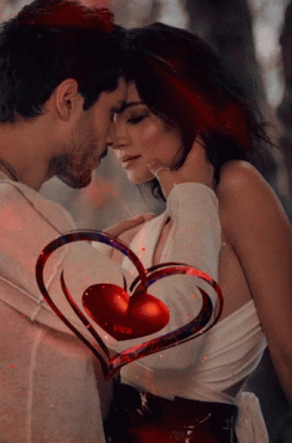A Man And Woman Are Kissing With A Heart That Says Vica On It GIF