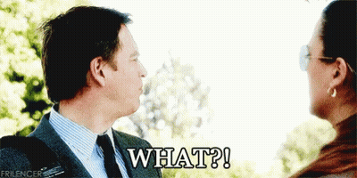 A Man And Woman Are Looking At Each Other And The Man Is Saying " What " GIF