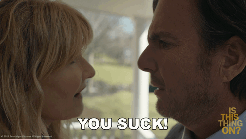 A Man And Woman Are Looking At Each Other And The Woman Says You Suck GIF