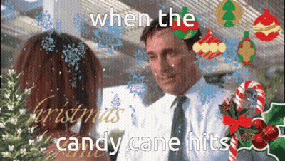 A Man And Woman Are Looking At Each Other With Candy Canes In The Background GIF