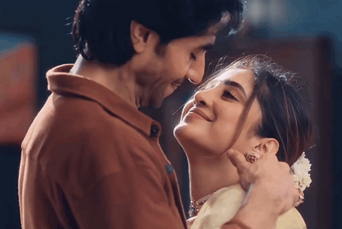 A Man And Woman Are Looking Into Each Other 'S Eyes And Smiling GIF