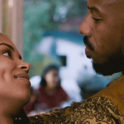A Man And Woman Are Looking Into Each Other 'S Eyes GIF