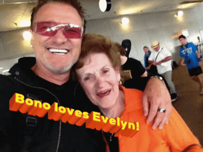 A Man And Woman Are Posing For A Picture And The Caption Says Bono Loves Evelyn GIF