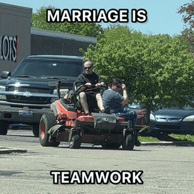 A Man And Woman Are Riding A Lawn Mower With The Words Marriage Is Teamwork Below Them GIF