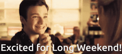 A Man And Woman Are Sitting At A Table With The Words Excited For Long Weekend Written Below Them GIF