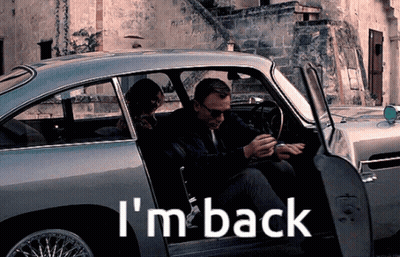 A Man And Woman Are Sitting In A Car With The Words I 'M Back On The Side GIF