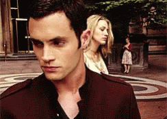 A Man And Woman Are Standing Next To Each Other GIF