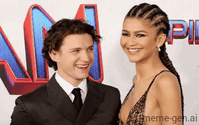 A Man And Woman Are Standing Next To Each Other On A Red Carpet And Smiling . GIF
