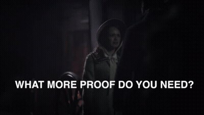 A Man And Woman Are Standing Next To Each Other With The Words What More Proof Do You Need Below Them GIF