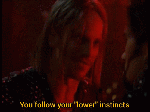 A Man And Woman Are Talking In A Dark Room And The Woman Says " You Follow Your " Lower " Instincts GIF