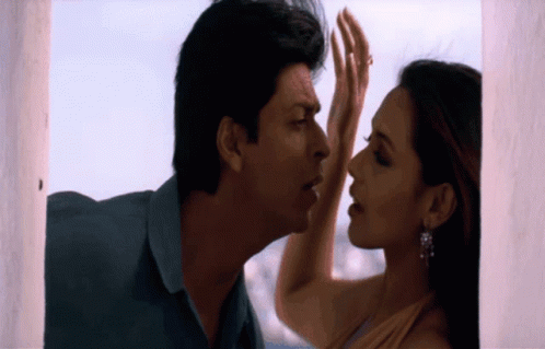 A Man And Woman Are Touching Each Other 'S Foreheads GIF