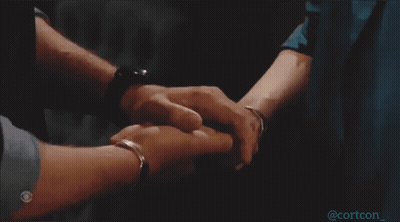 A Man And Woman Holding Hands With A Cbs Logo On The Bottom Right GIF