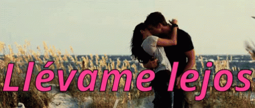 A Man And Woman Kissing In Front Of The Ocean With The Words Llevame Lejos Written In Pink GIF