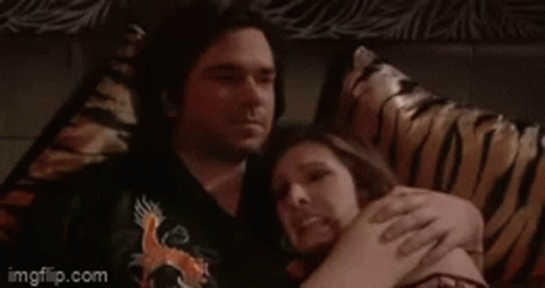 A Man And Woman Laying On A Bed With The Words Oh Goooood Written Above Them GIF