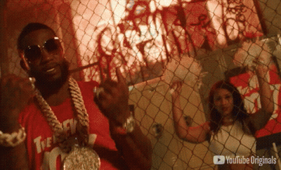 A Man Behind A Chain Link Fence With A Youtube Originals Logo GIF