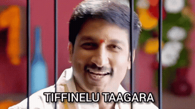 A Man Behind Bars With The Words Tiffinelu Taagara On The Top GIF
